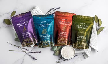 Bokek organic scented dead sea salts in pouches on a marble surface