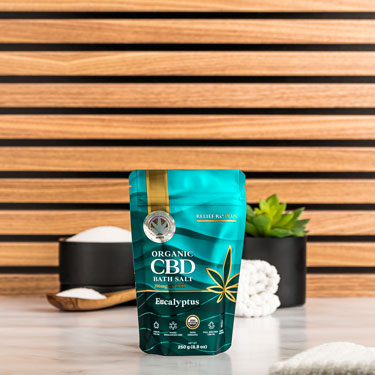 Organic CBD eucalyptus scented bath salts on a bathroom counter - 250g pouch