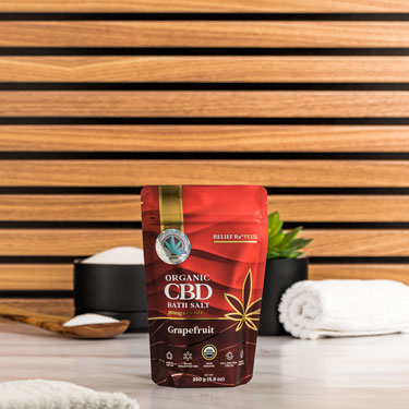 Organic CBD grapefruit scented bath salts on a bathroom counter - 250g pouch