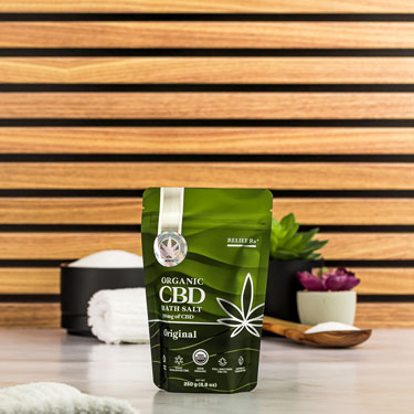 Organic CBD bath salts on a bathroom counter - 250g pouch