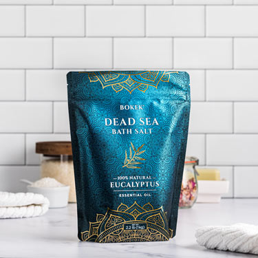 Organic Eucalyptus dead sea bath salts on a bathroom counter - 2.2 lb bag