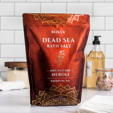 Organic Neroli dead sea bath salts on a bathroom counter - 5 lb bag