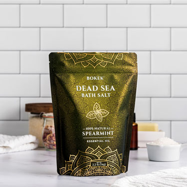 Organic Spearmint dead sea bath salts on a bathroom counter - 2.2 lb bag