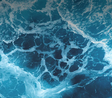 Ocean waves crashing from a birdseye perspective